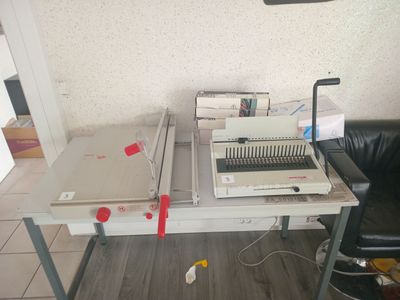 a desk with a computer and a printer on it