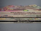 a lot of books that are stacked on top of each other