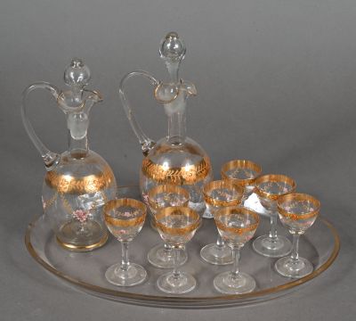 bottles and glasses on a tray on a table with a gray background