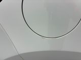 a close up of a car ' s door handle with a reflection of a person in the mirror