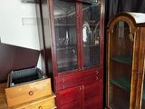 a wooden cabinet with a glass door in a room
