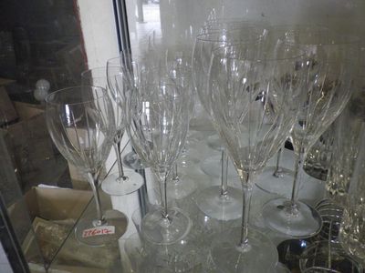 many empty wine glasses sitting on a glass table