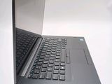 a laptop computer that is open on a white surface