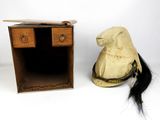 a hat sitting next to a desk with a hat on top of it