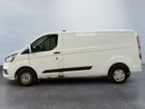 the white van is parked on the concrete floor in the room