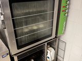 a silver oven sitting in the middle of a kitchen