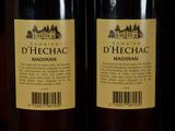two bottles of wine sitting on top of a table next to each other