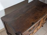 a wooden dresser with a mirror on top of it