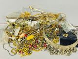 a pile of gold and silver jewelry on a table