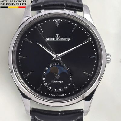 a close up of a watch with a black dial