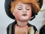 two dolls that are sitting next to each other
