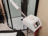 a bathroom with a shower and a chair in it