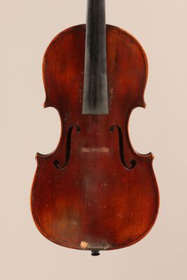 an old violin with a bow hanging from it ' s back