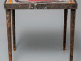 an old table with a red and white design on it