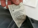 someone is holding a piece of paper that has been taped to the back of a shirt