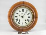 a wooden clock with roman numerals on the face
