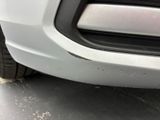 a close up of a car ' s front bumper with scratches on it