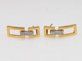 a pair of gold and diamond cuff earrings
