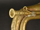 a gold trumpet sitting on top of a black table
