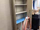 a metal cabinet with a hose in it in a room
