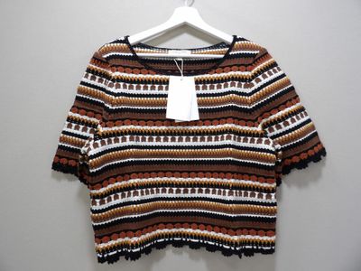 a close up of a shirt on a hanger on a wall