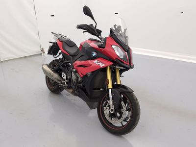 a red and black motorcycle parked in a white room