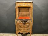 an old wooden cabinet with drawers and drawers on top of it
