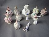 many figurines of women dressed in white and pink dresses