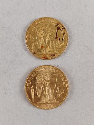 a close up of two gold coins on a white surface