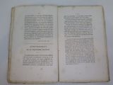 a book open on a white table with a picture on it