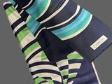 a blue, green and white striped scarf on a gray background