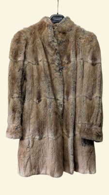 une photo d'un manteau de fourrure suspendu à un cintre