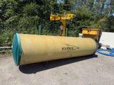 a large yellow barrel sitting in the middle of a parking lot