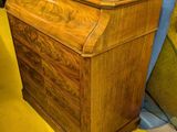 a woman that is standing next to a wooden box