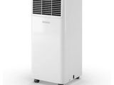 a white air conditioner sitting on top of a white table