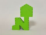 green wooden letter k on a white surface with a white background