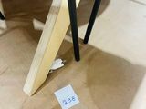 a sign on the floor of a room that has a table and chairs in it