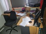 a desk with a computer, keyboard, mouse and other items on it