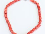 a red coral beaded necklace on a silver chain