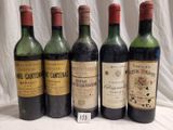 several bottles of wine are lined up on a table