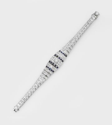 an image of a diamond and sapphire bracelet on a white background