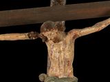 a statue of jesus on a cross with a black background
