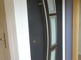 a black front door with a glass panel on it