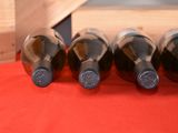 several bottles of wine are lined up on a red table