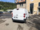 a white van parked in front of a building