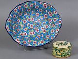 a close up of a plate and a small container on a table