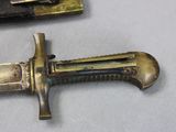 two knives that are sitting on a table