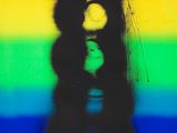 rainbow colored photograph of a person holding a teddy bear in front of a rainbow colored background