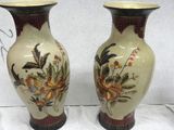 two vases that are sitting on a table