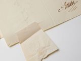a piece of paper with writing on it next to a pair of scissors